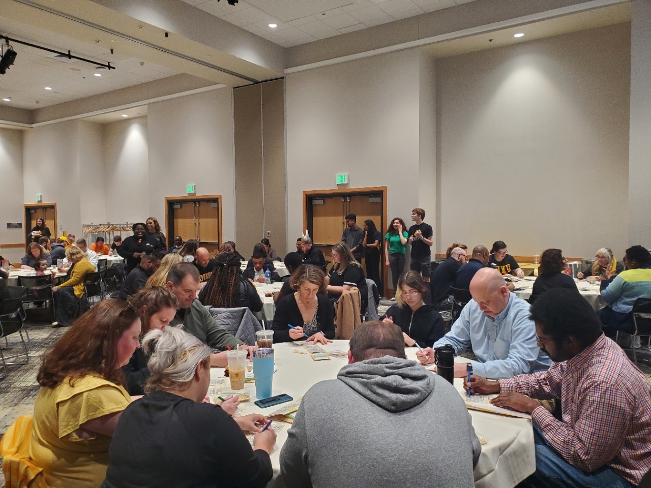 Faculty and staff sitting around a table playing bingo