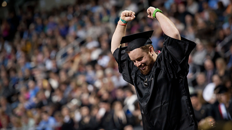 A student celebrating graduation from NKU