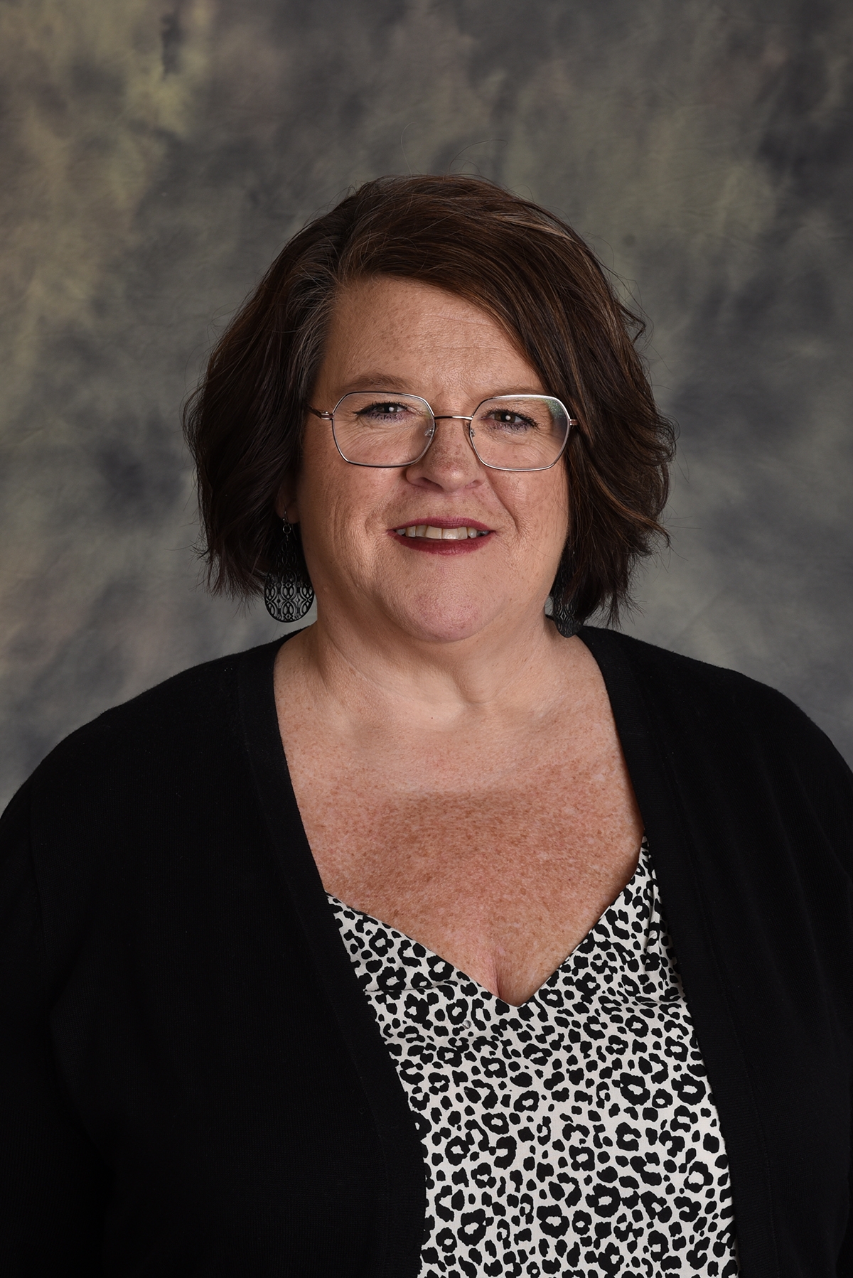 image of professional woman with dark hair and glasses
