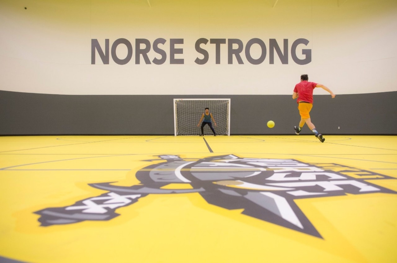 Students playing indoor soccer on Campus Rec MAC Court