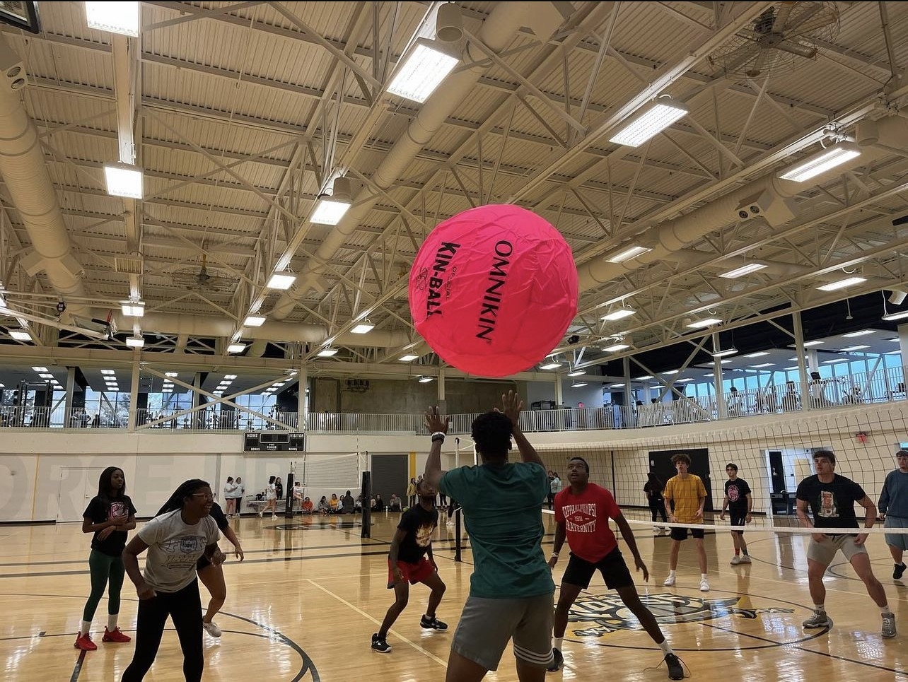Students participating in big pink volleyball