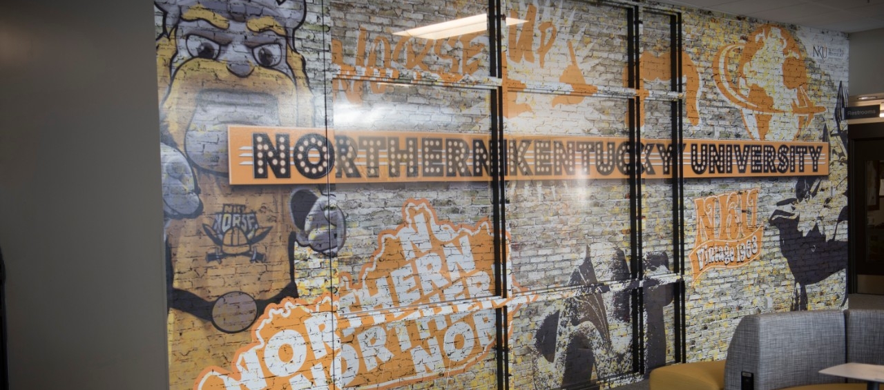 Waiting area featuring colorful wallart featuring Victor E. Viking and the title Northern Kentucky University