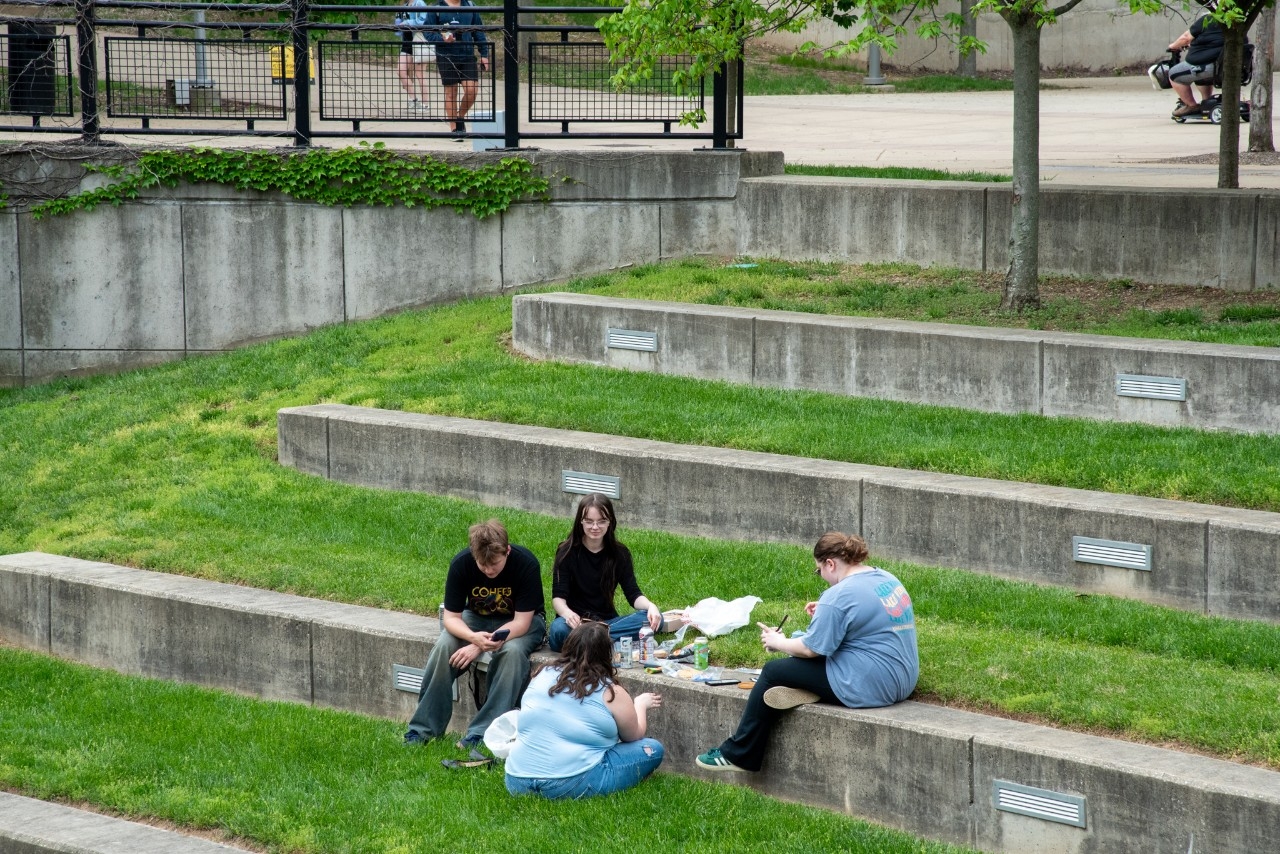 Students sitting together outdoors on NKU's campus.