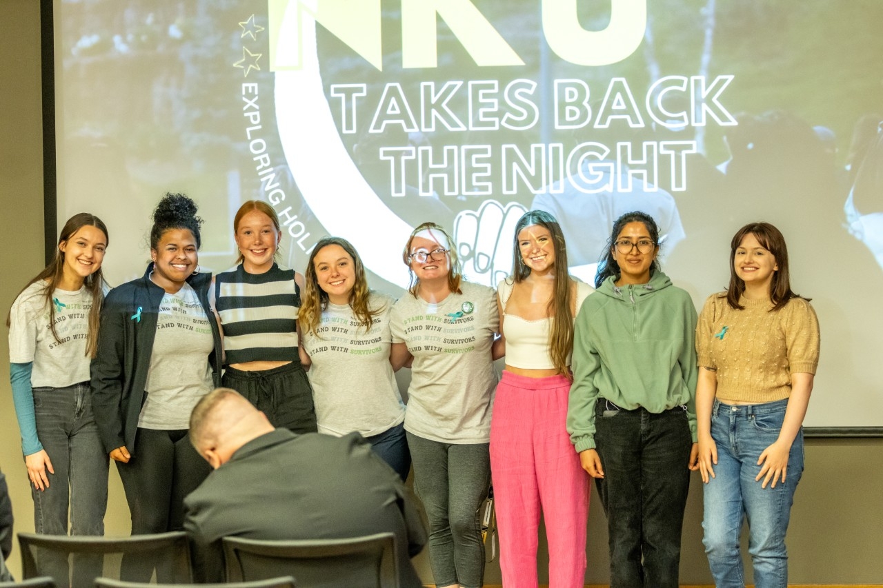 Peer Ambassadors standing in front of a Take Back the Night logo
