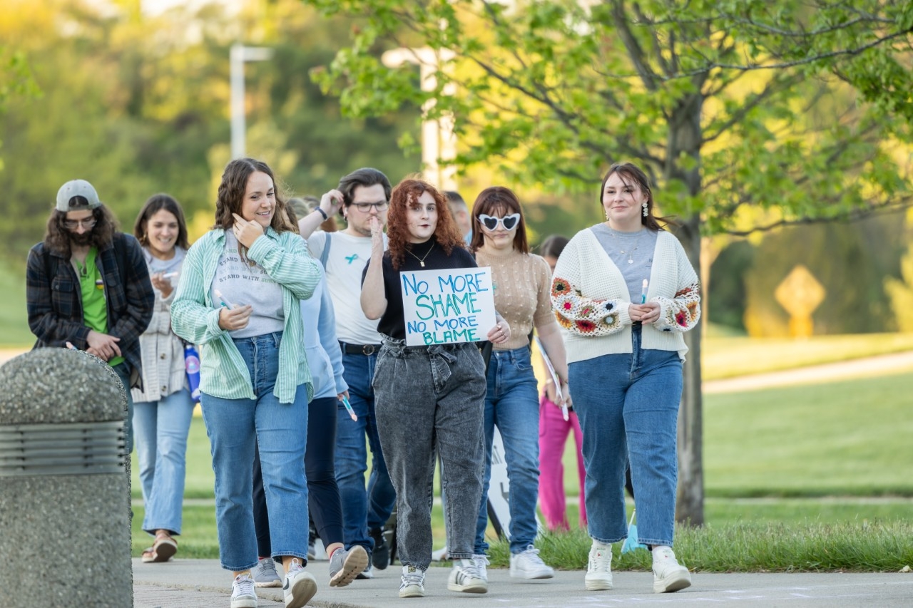 Students and staff marching on campus with signs