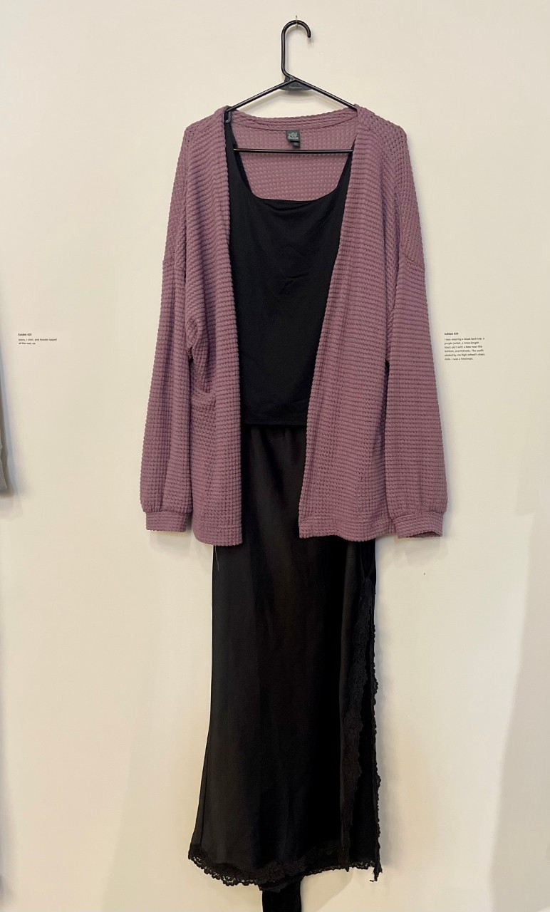 black tank top under a purle cardigan, black skirt, and black fishnets