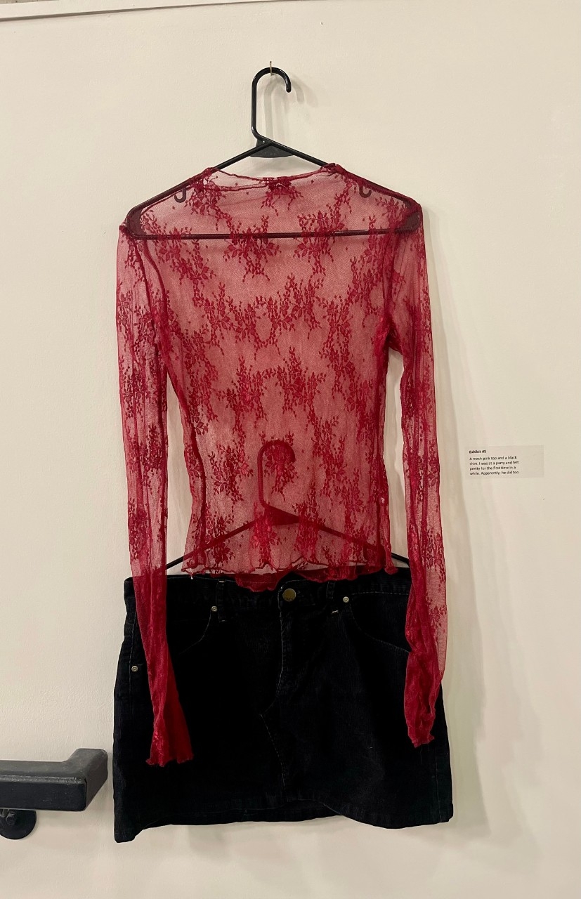 Red mesh shirt with flowers, short black skirt