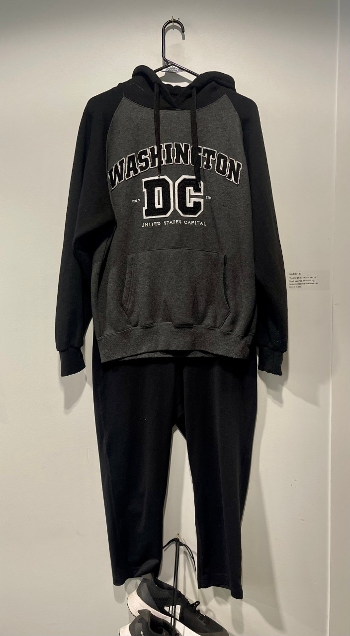 Grey and black sweatshirt, black leggings, sneakers