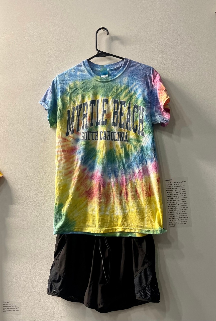 Blue, pink, and yellow tie dye t-shirt and black running shorts