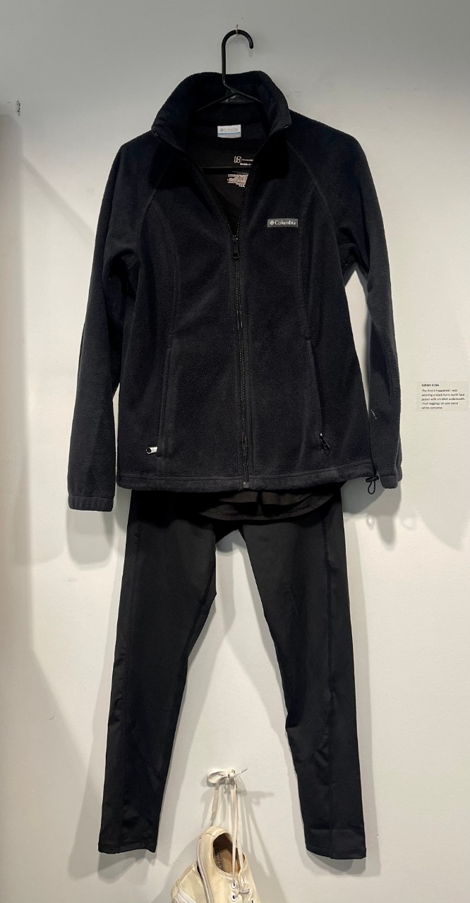 Black fuzzy jacket, black leggings, white sneakers