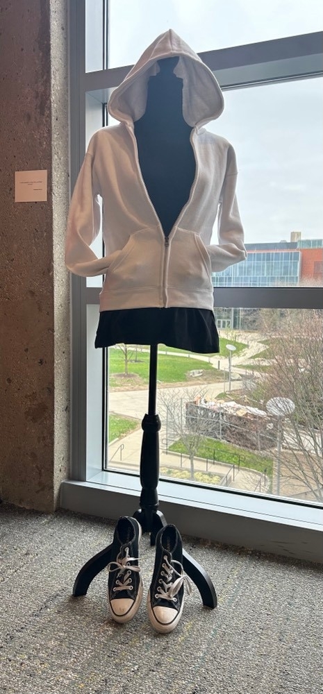 White hoodie over black shirt and skirt with black converse shoes