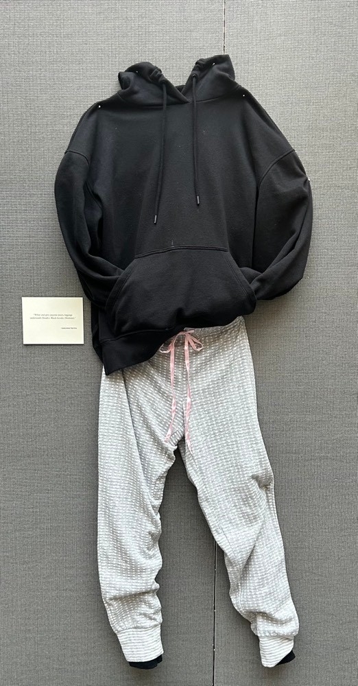 Black hooded sweatshirt and white and gray pajama pants