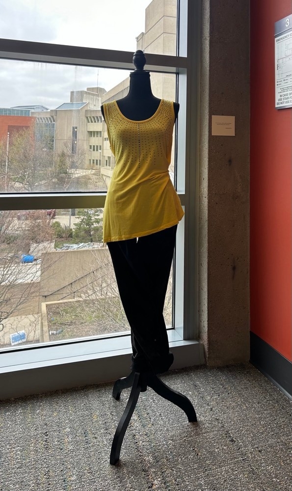 Yellow tank top with skinny jeans on a mannequin 