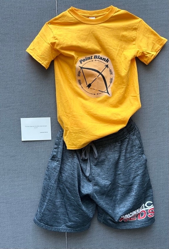 yellow archery t-shirt and gray gym shorts