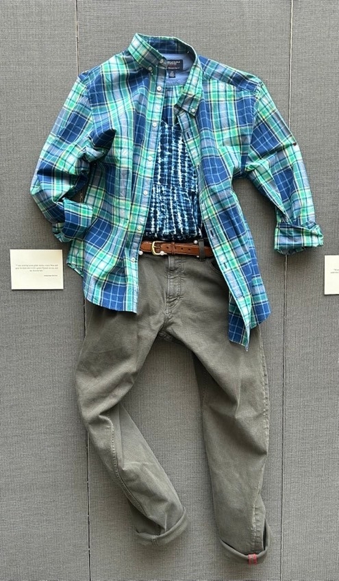Green pants with blue tie-dyed t-shirt under a green plaid shirt