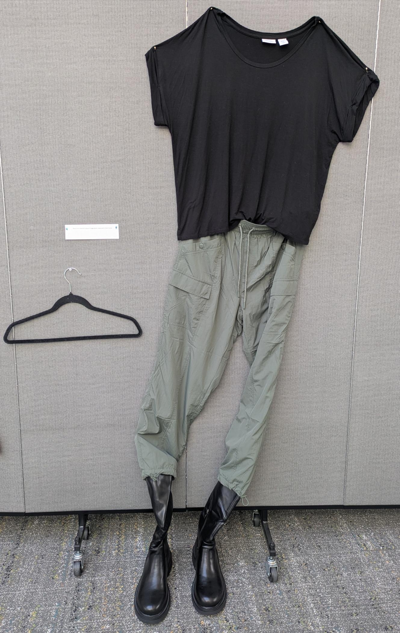 black short sleeved bodysuit with green cargo pants and black boots.