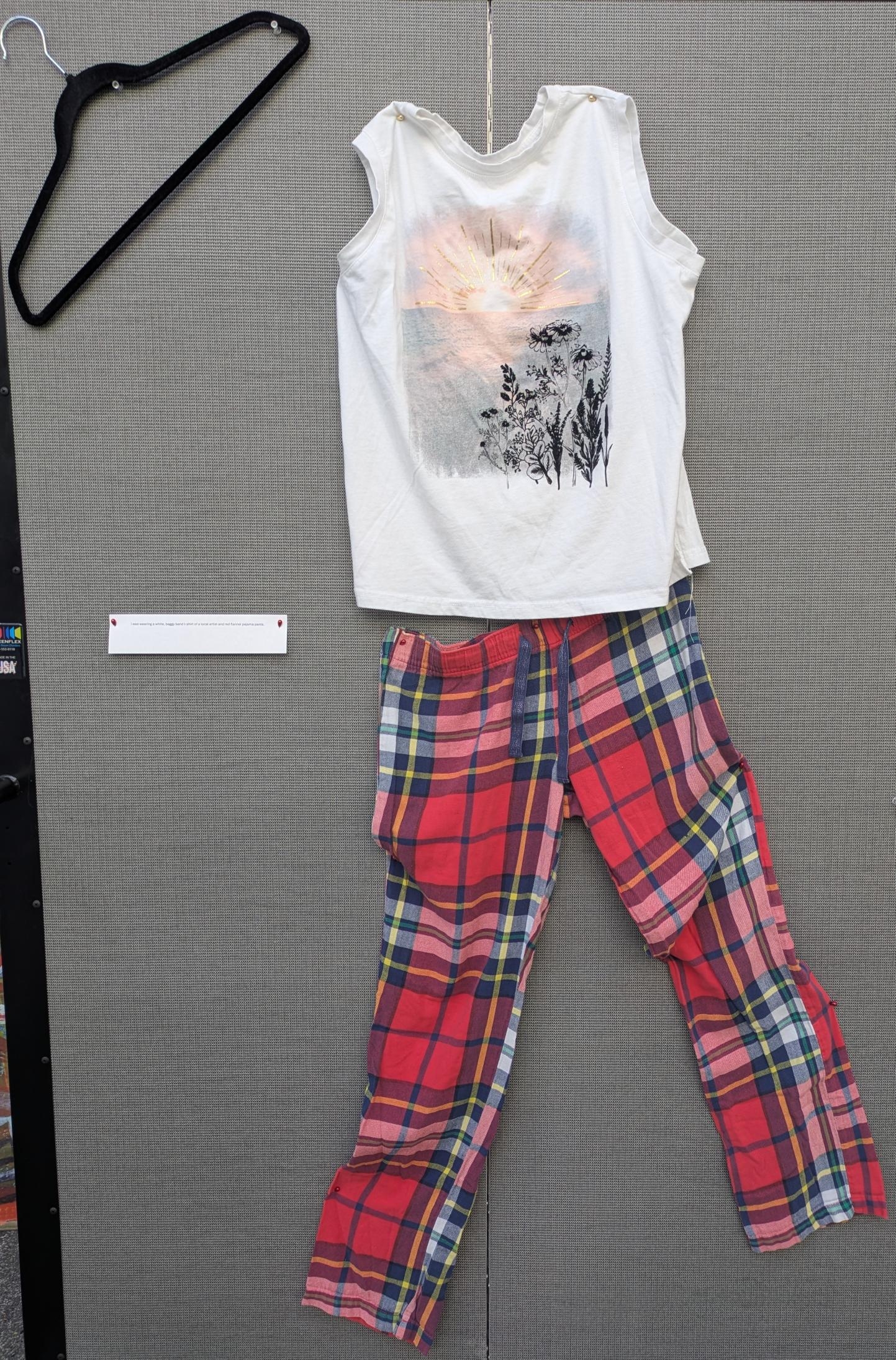 White graphic tshirt and red flannel pajama pants.