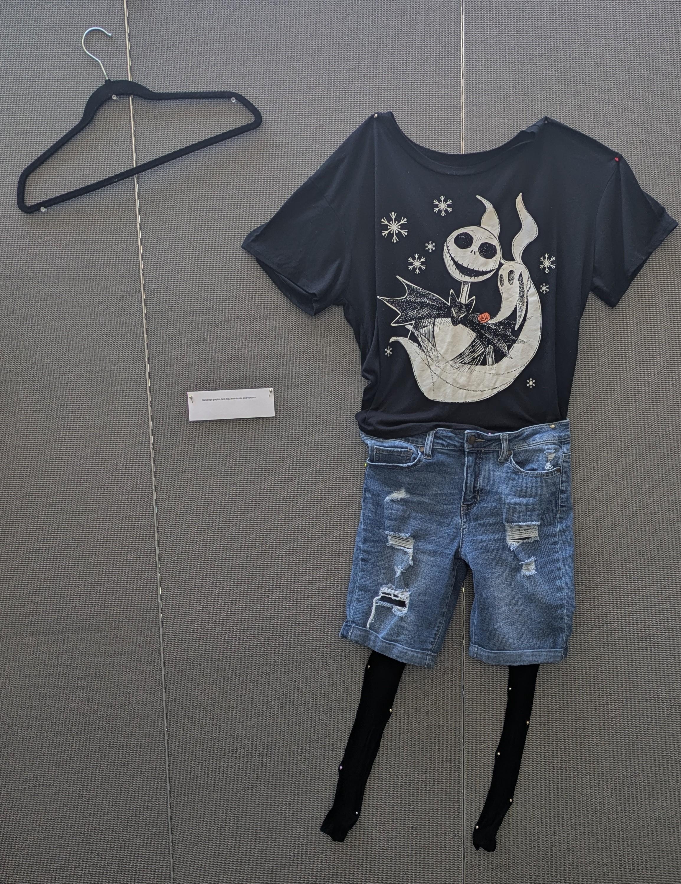 Black graphic tshirt, jean shorts, and black fishnets.