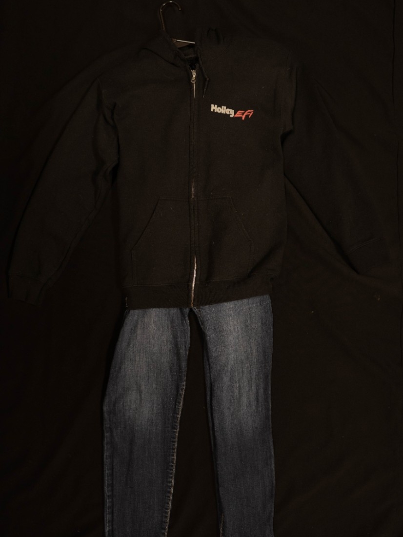 Exhibit displays standard blue jeans with black hoodie. 