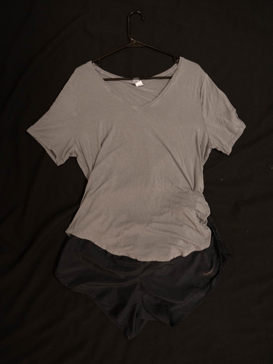 Exhibit displays an oversized gray t-shirt with black athletic shorts. 