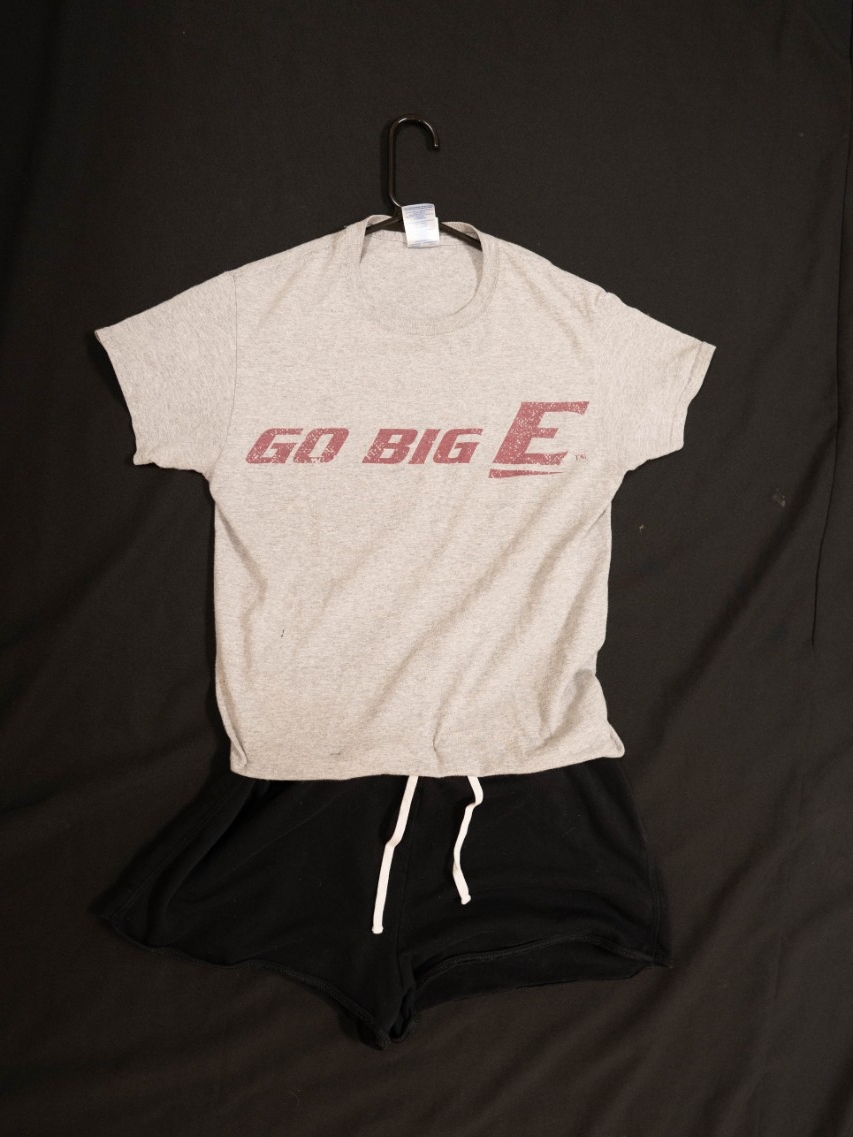Exhibit displays a gray EKU t-shirt with “Go Big E” written across the center and black cotton shorts. 