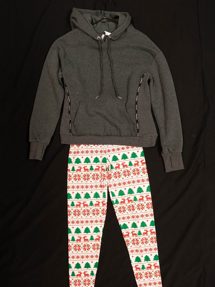 Exhibit displays a gray oversized hoodie and white leggings with a Christmas print. 