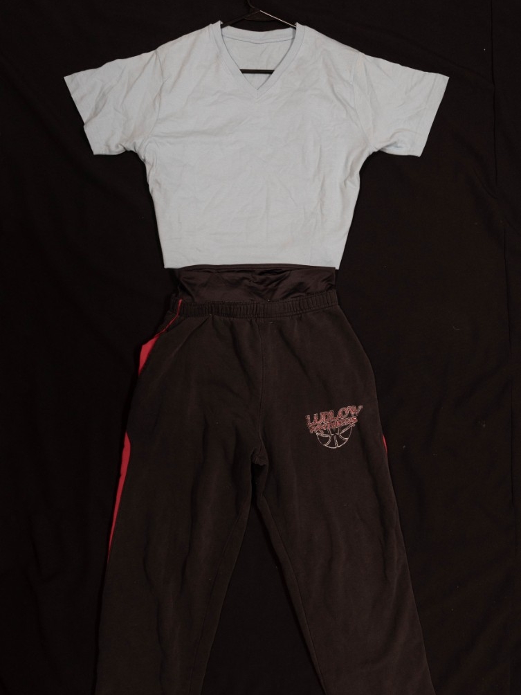 Exhibit displays black sweatpants with black spandex shorts and an oversized blue t-shirt. 