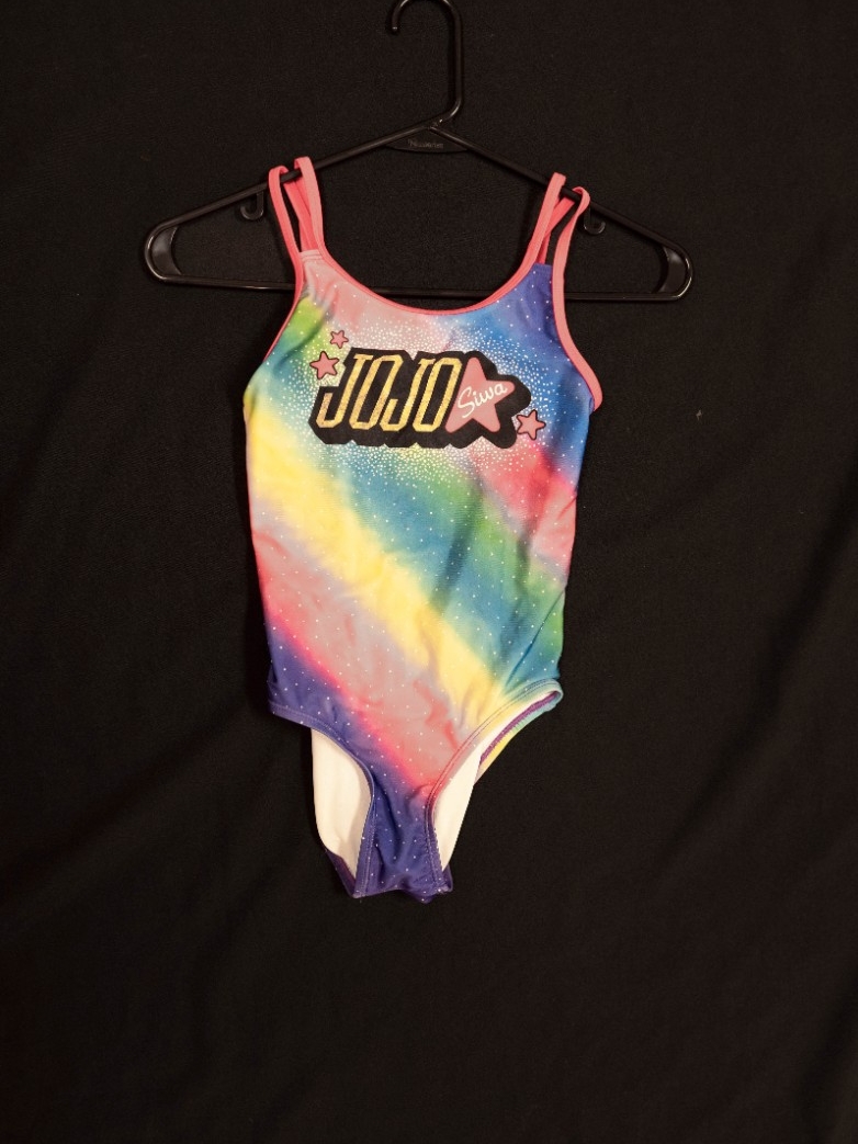 Exhibit displays a child’s Jojo Siwa rainbow bathing suit. 