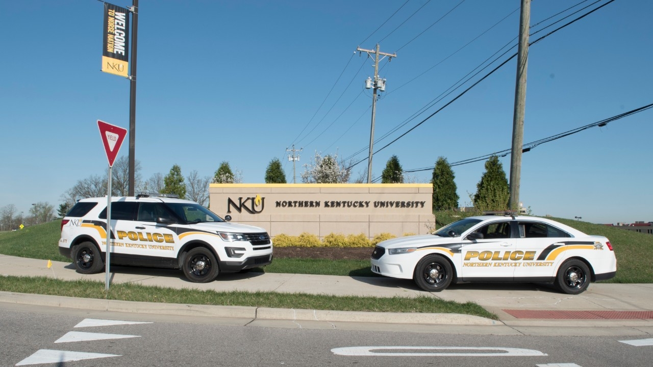 Two police cars in front of NKU sign