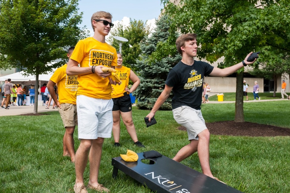 students playing cornhole
