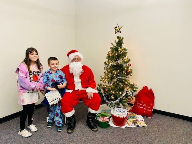 Kids visiting with Santa Claus