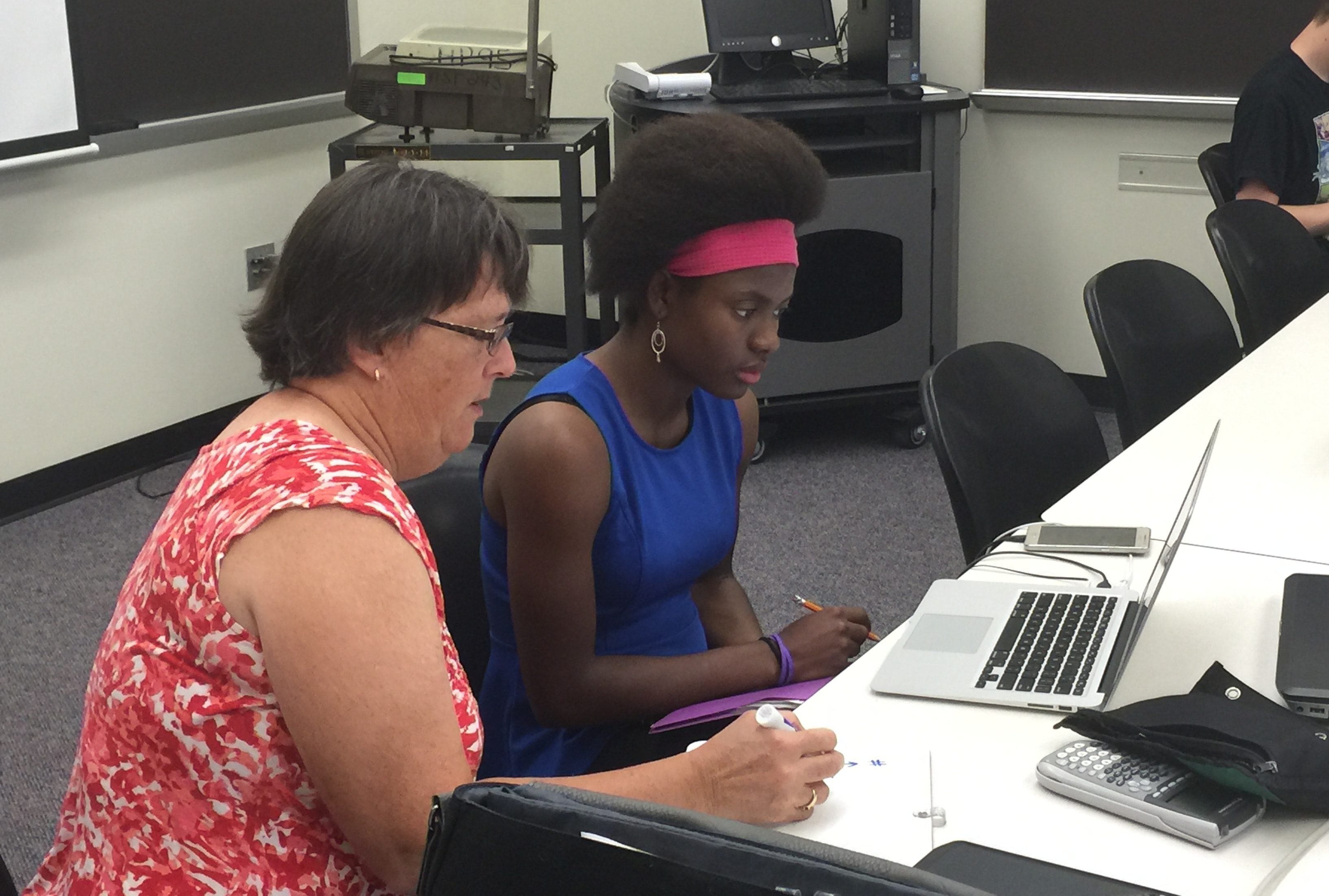 A student with teacher helping