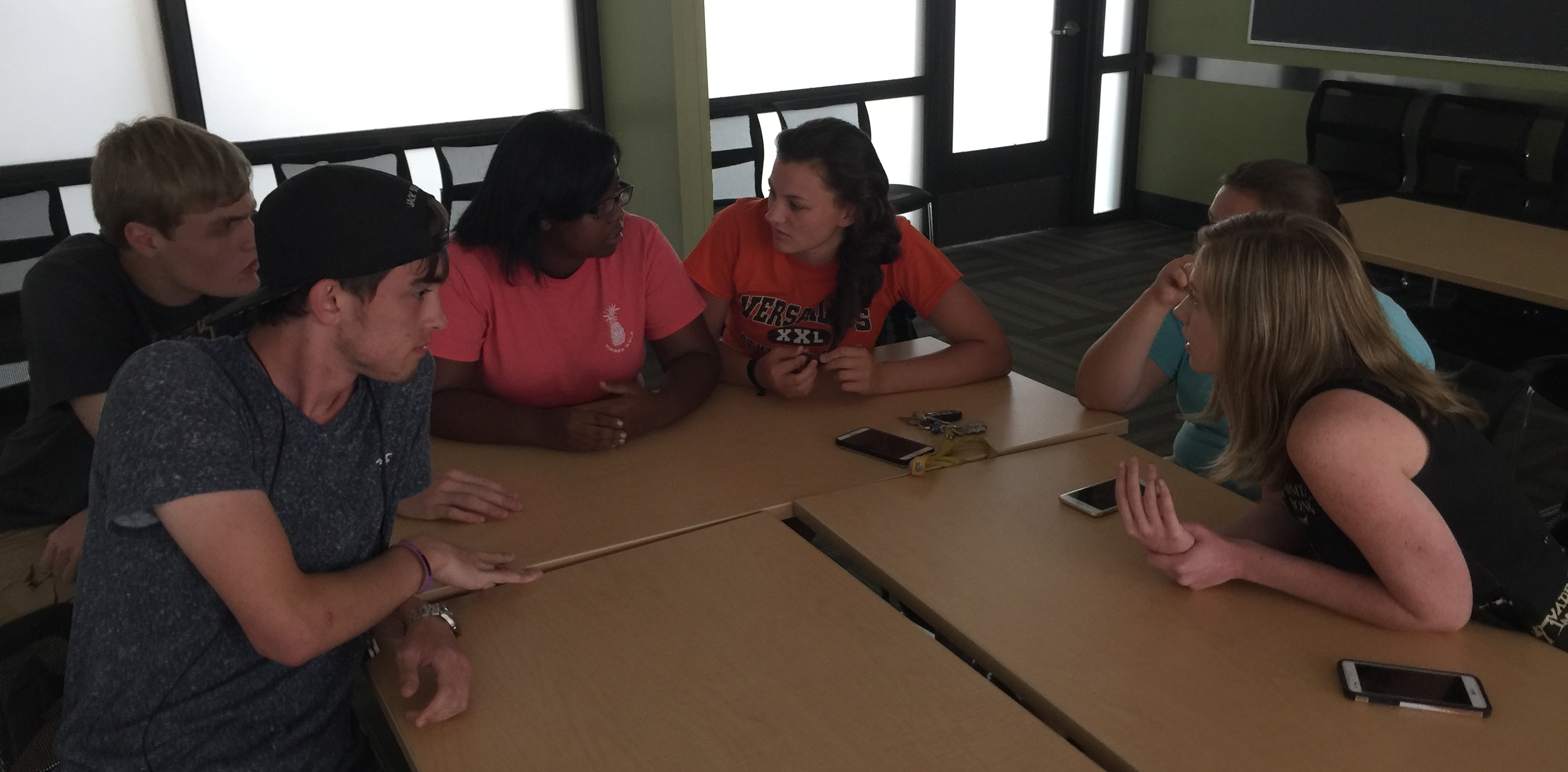 Students discussing at a table