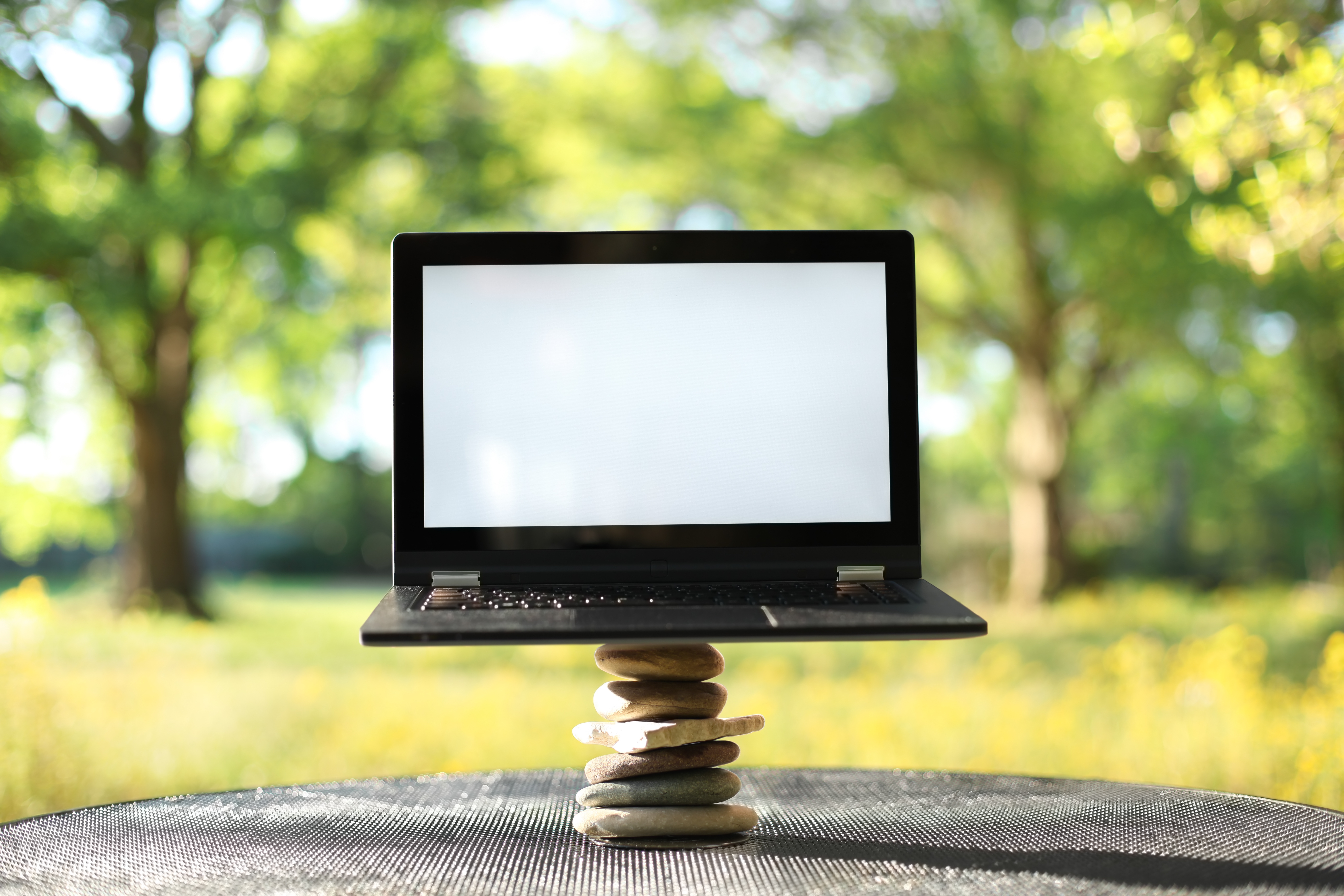 Balanced rocks next to a computer