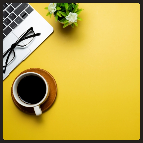 Laptop and drink on a desktop