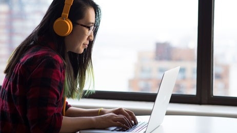 Student at a laptop in the Steely Library