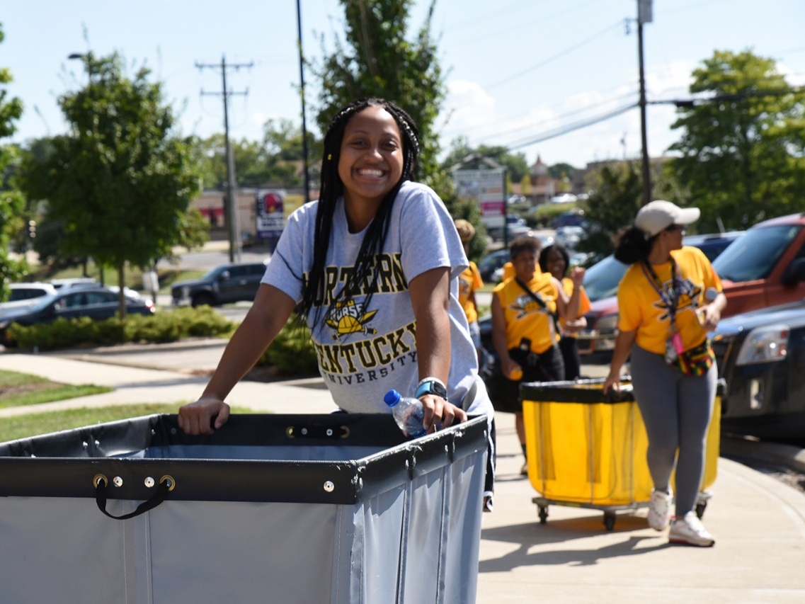 Students volunteering to move furniture into dorms during NKU move-in day.