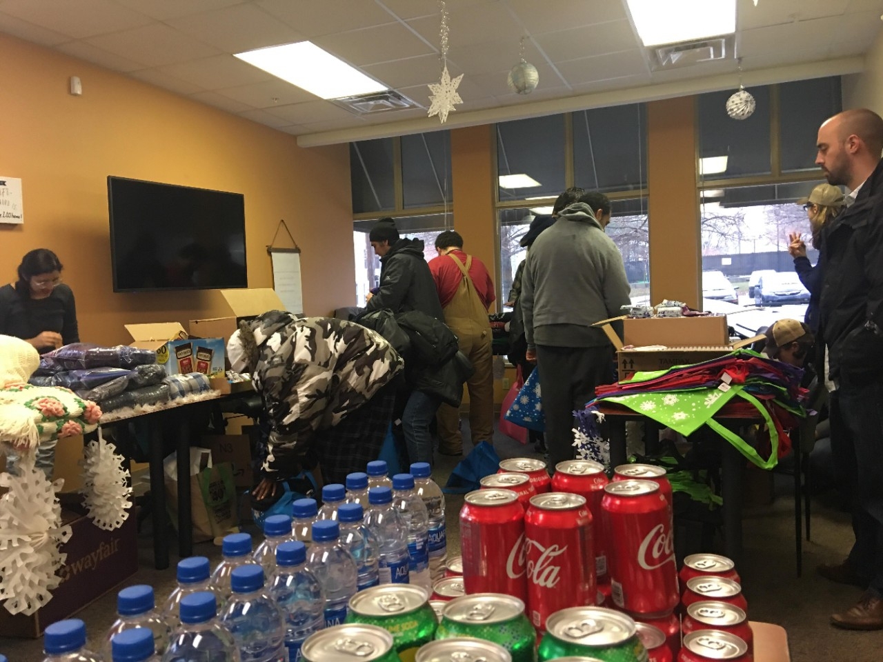 Volunteers sorting food and drink at a homeless shelter.