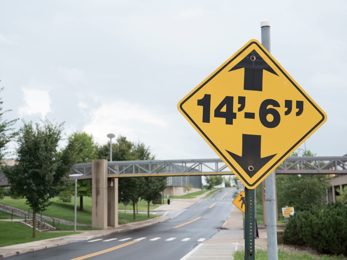 Traffic sign outside of Griffin Hall parking lot, indicating the maximum height of 14 feet and 6 inches. 
