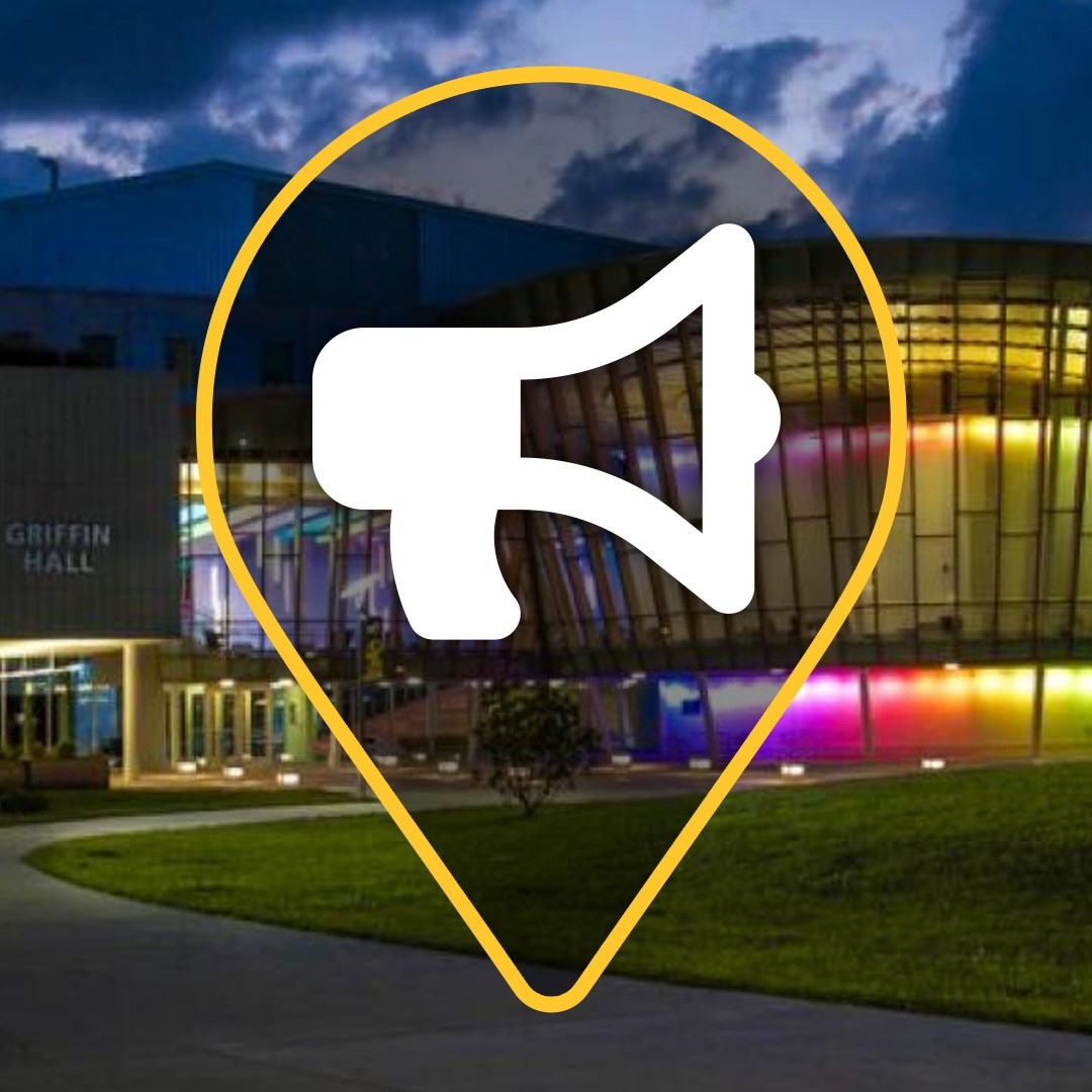 COI exterior building illuminated at night with colorful lights