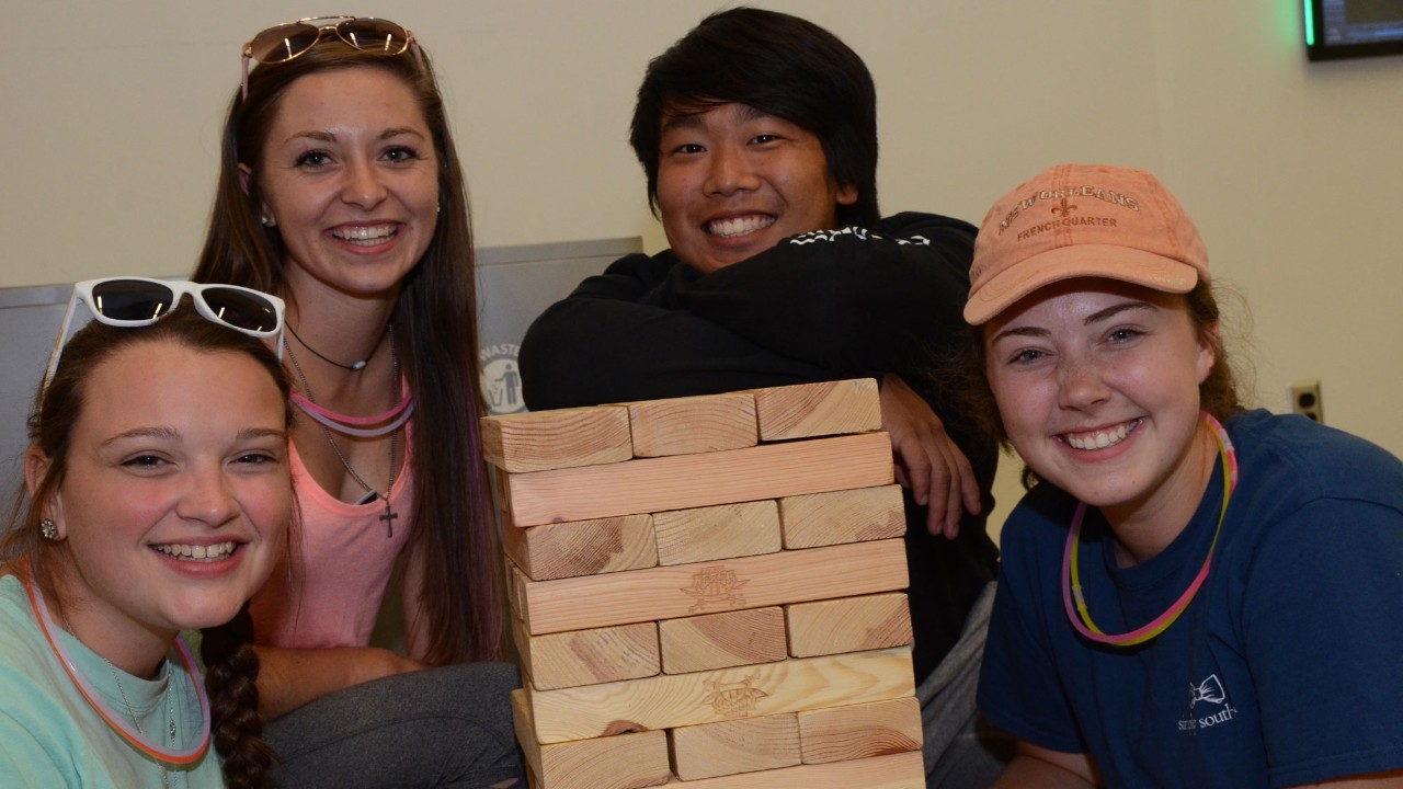 Students attending Victorfest playing Jumbo Jenga