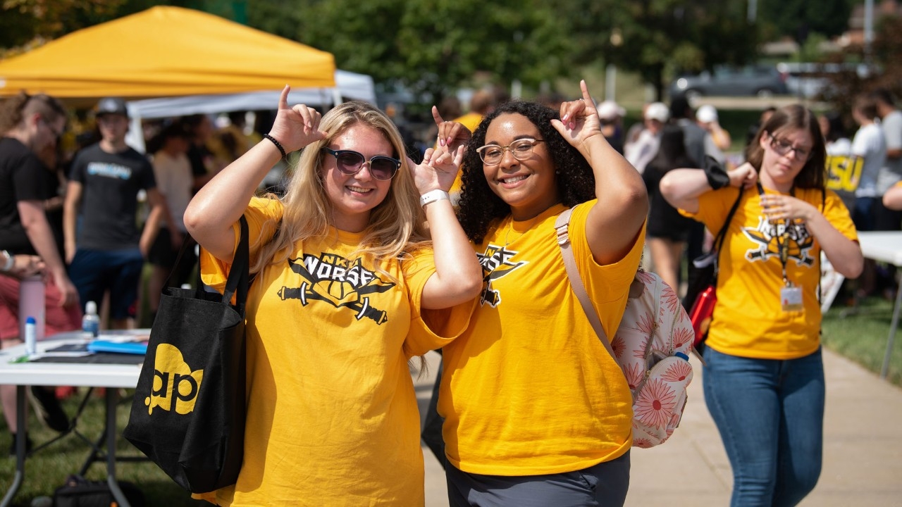 Students attending Victorfest giving a NorseUp
