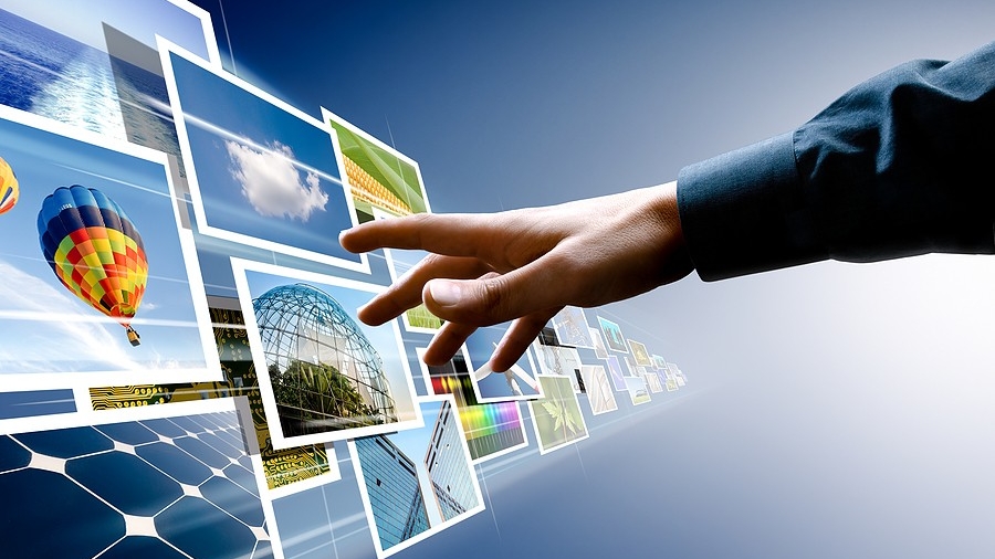 Hand reaching out to many images flying past on a blue background