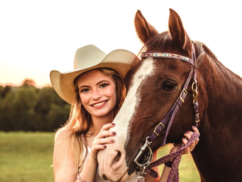 Alisha Detmer standing with her horse