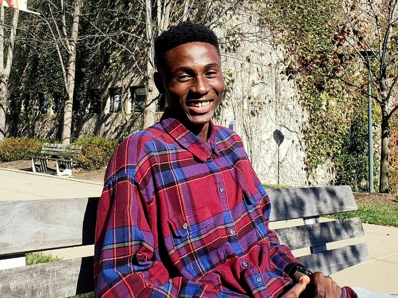 Joshua Osakwe smiling for the camera on campus
