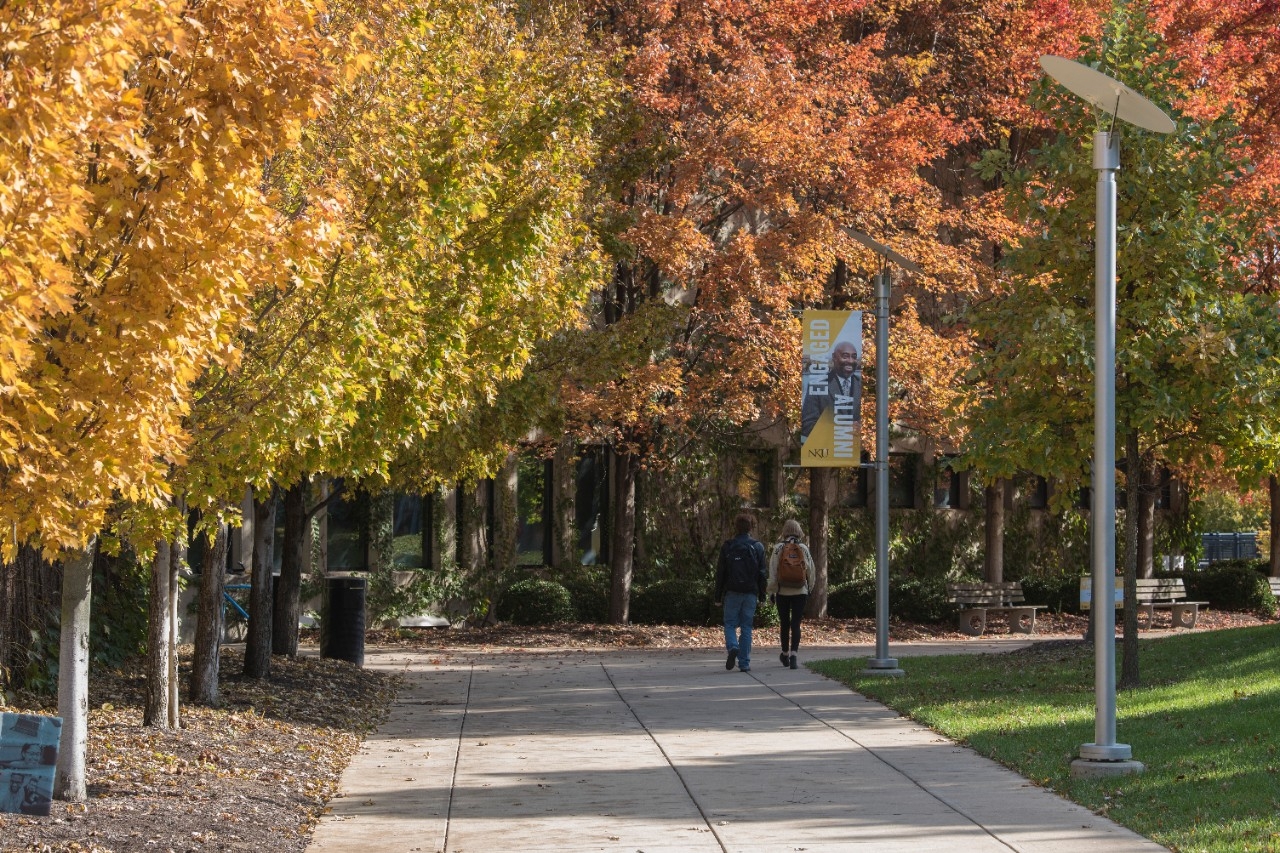 Photo of an NKU pathway lined with vibrant fall-colored leaves (in place of missing student photo)