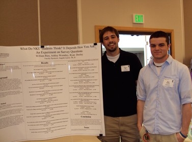 Two students showcashing their research at Celebration of faculty research